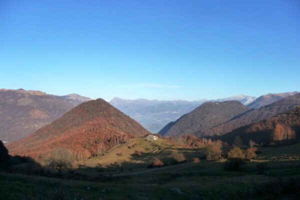 The pastures of Pian delle Alpi and the cone shaped mountain of San Zeno